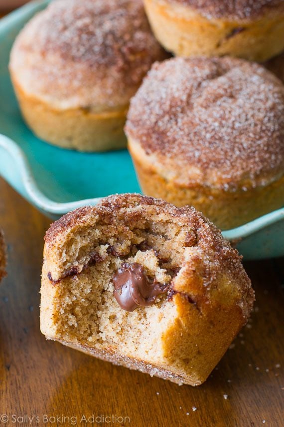 cinnamon sugar muffins stuffed with Nutella with a bite taken out of one showing the middle