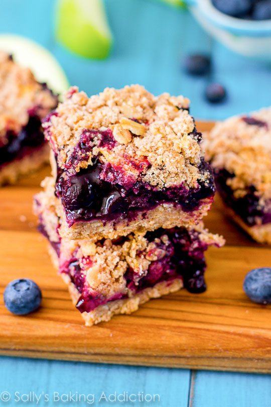stack of apple blueberry pie bars on a wood board