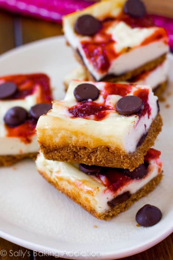 strawberry chocolate chip cheesecake bars on a white plate