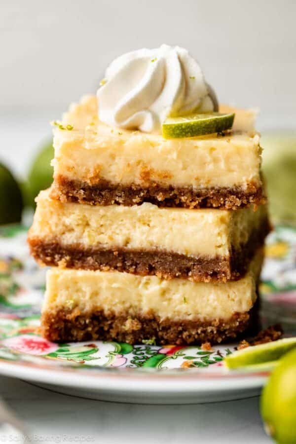 stack of 3 key lime pie bars on floral green plate.