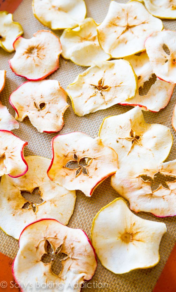 baked cinnamon apple chips on a silpat baking mat