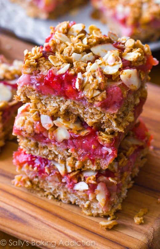 stack of 3 strawberry oat squares on a wood board