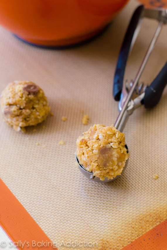 peanut butter cup oatmeal cookie dough in a cookie scoop on a silpat baking mat