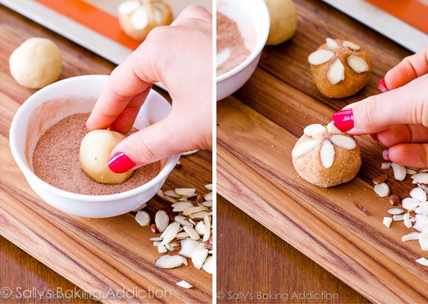 2 images of hands rolling cookie dough ball in cinnamon sugar mixture in a bowl and hand adding sliced almonds onto cookie dough ball