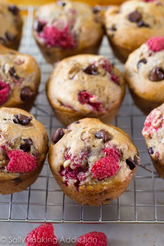 raspberry chocolate chip banana muffins on a cooling rack