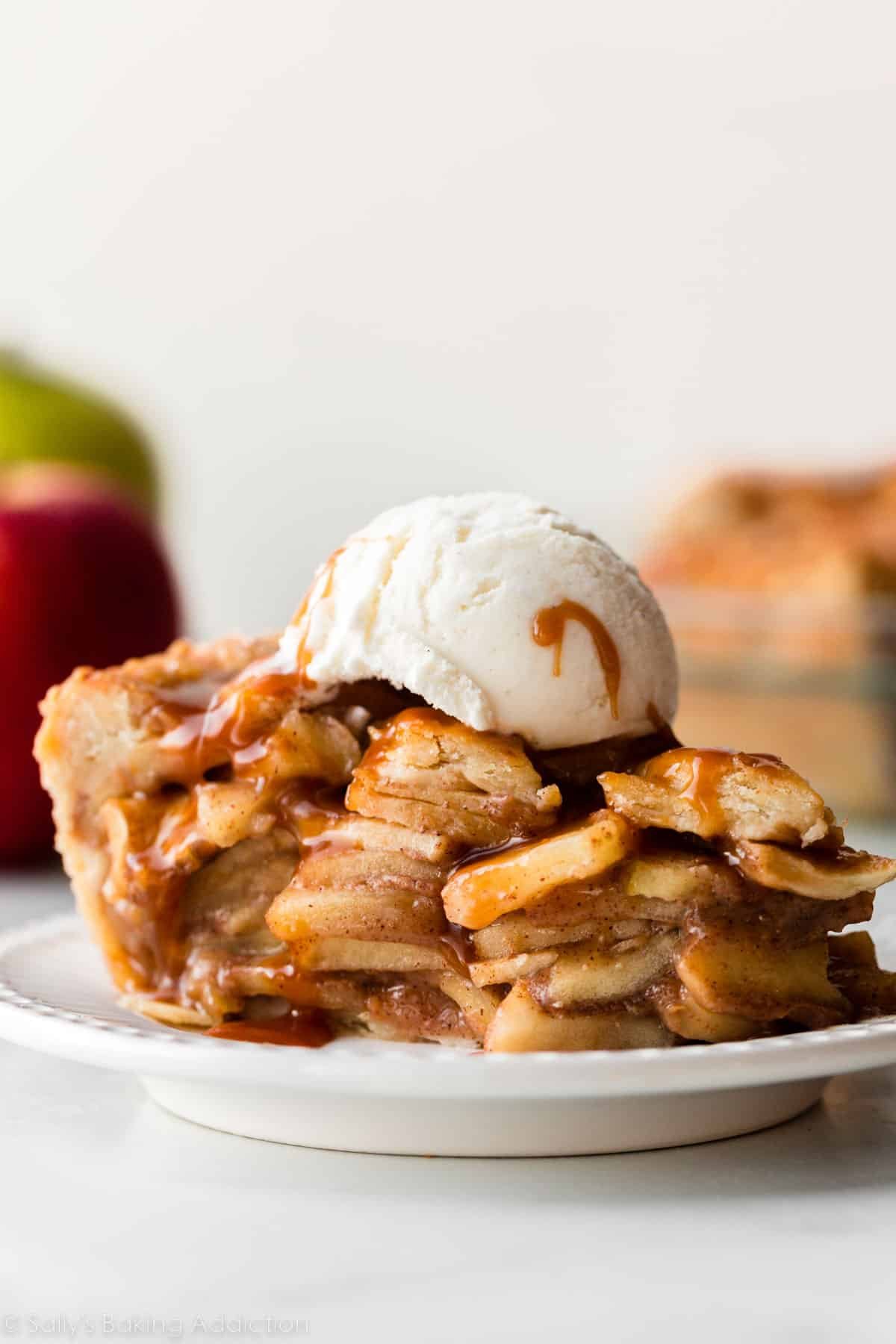 salted caramel apple pie slice with vanilla ice cream on top.