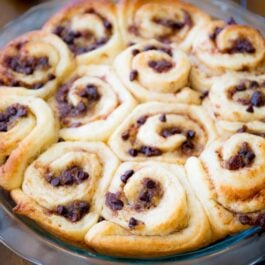 banana chocolate chip cinnamon rolls in a glass baking dish after baking