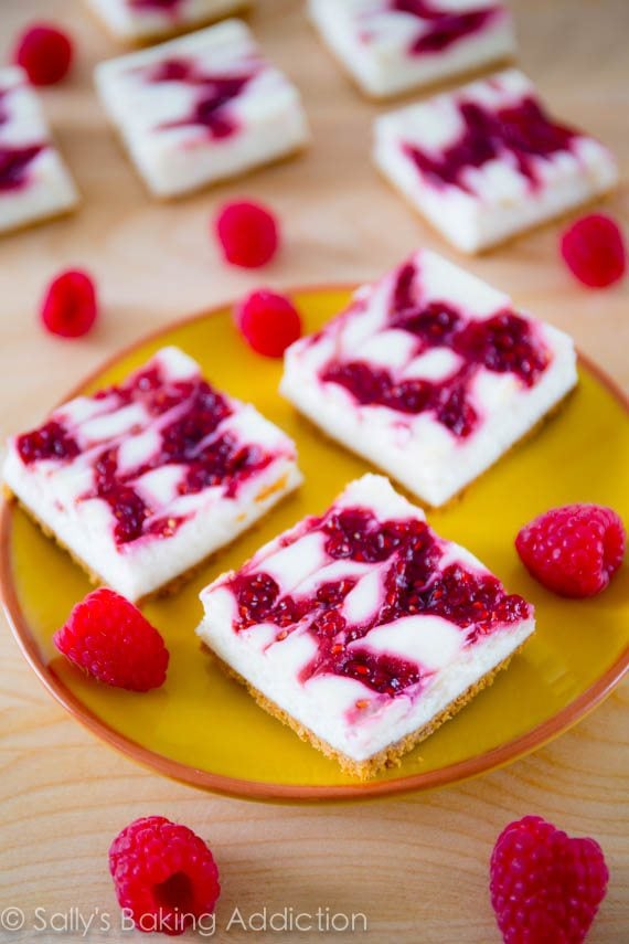 Skinny Raspberry Swirl Cheesecake Bars - these cheesecake bars taste like the real thing!  Except they are made with light cream cheese, yogurt, egg whites, and little sugar. Get the recipe sallysbakingaddiction.com