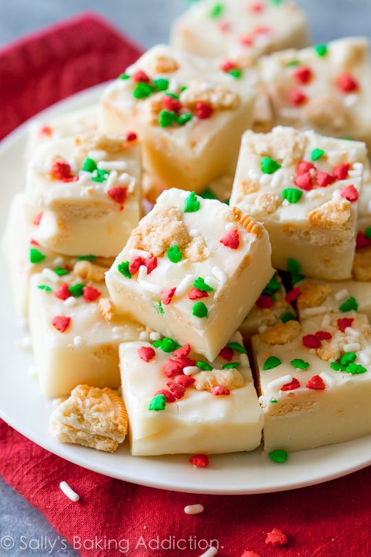 squares of golden Oreo fudge with Christmas sprinkles on a white plate