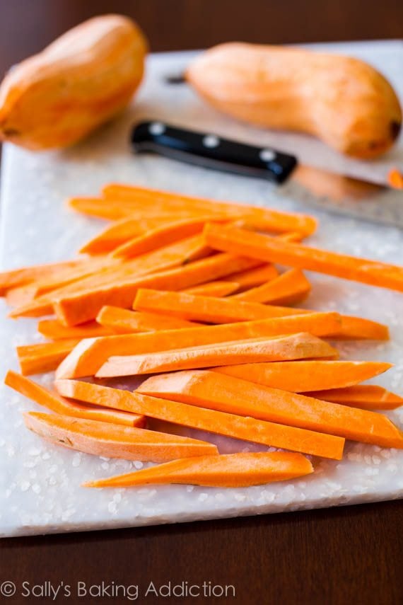 sliced sweet potatoes on a white cutting board