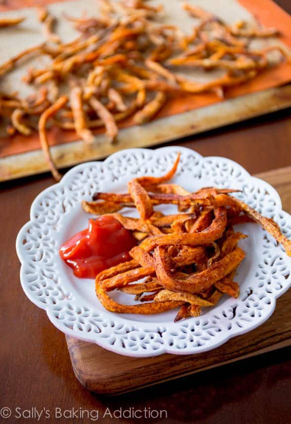 sweet potato fries on a white plate with ketchup
