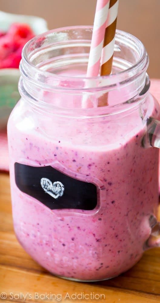 peanut butter and jelly smoothie in a glass mug with straws