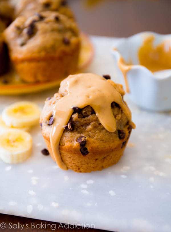 peanut butter banana muffins topped with melted peanut butter