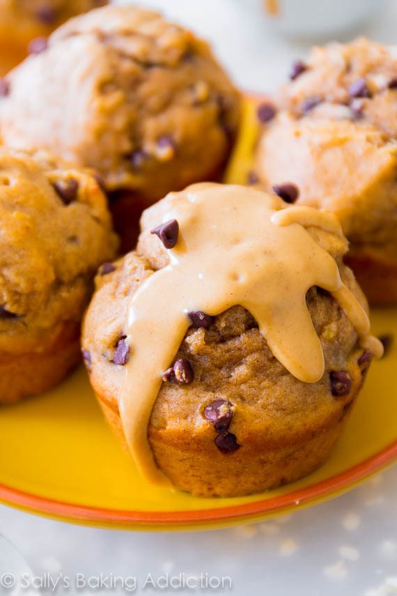 peanut butter banana muffins topped with melted peanut butter on a yellow plate