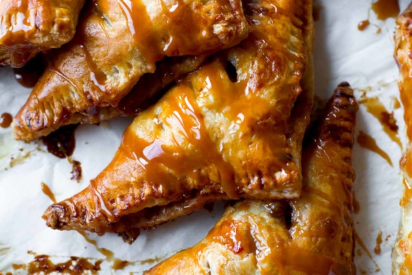 overhead image of caramel apple turnovers with a drizzle of salted caramel sauce