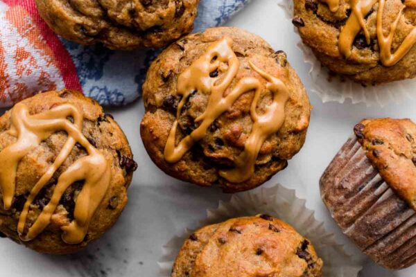 healthier peanut butter banana muffins with mini chocolate chips and blue linen napkin.