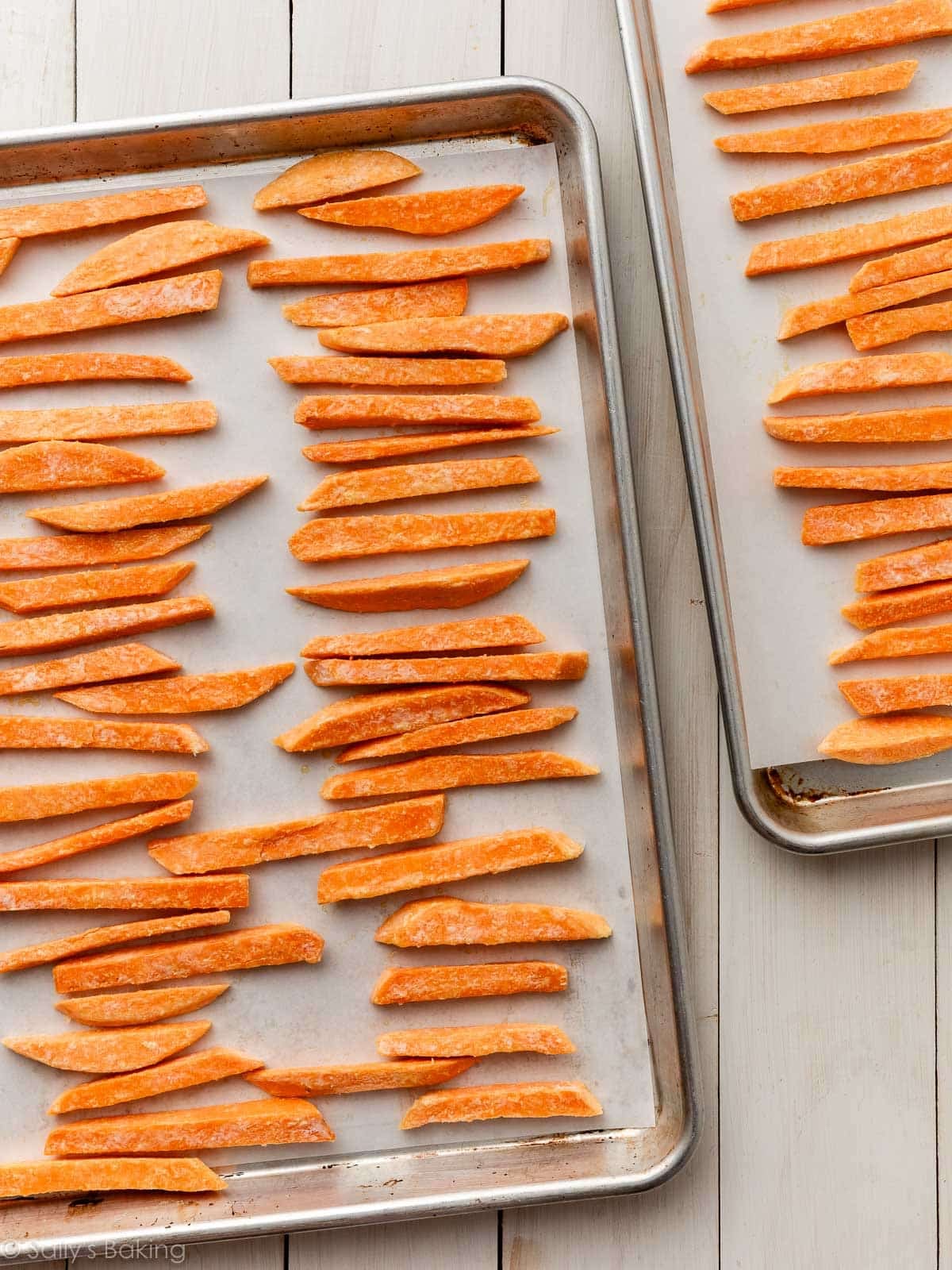 sweet potatoes lined on baking sheets.