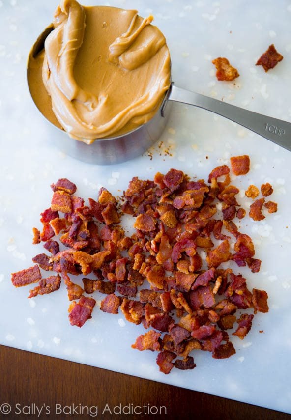 peanut butter in a measuring cup and chopped bacon on a cutting board
