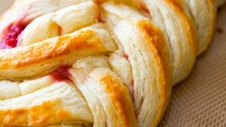 close-up photo of a pastry braid with raspberry filling
