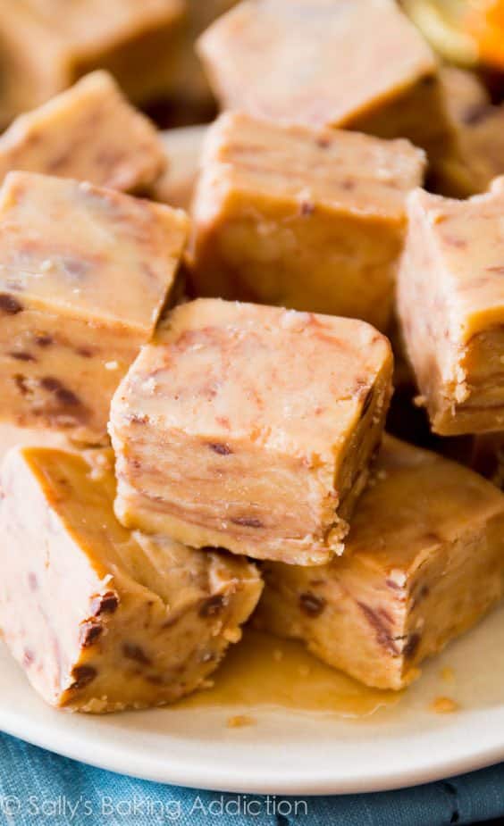 squares of peanut butter fudge piled on top of a white plate