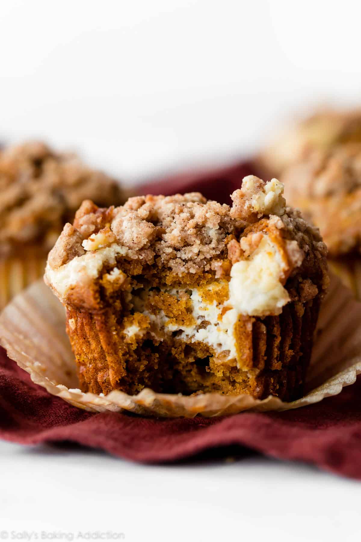 pumpkin muffin filled with cream cheese and topped with crumb