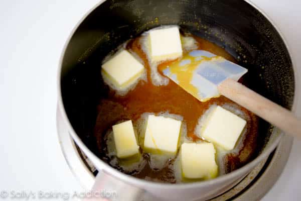 chunks of butter and melted sugar in a saucepan for salted caramel sauce