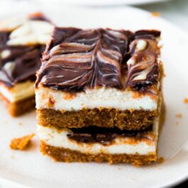 stack of Nutella swirl cheesecake bars on a white plate
