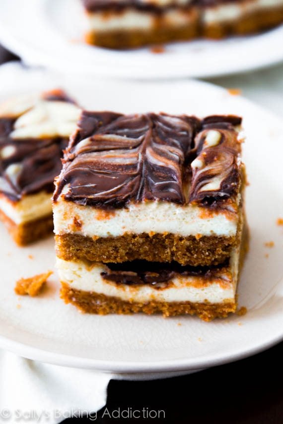 stack of Nutella swirl cheesecake bars on a white plate