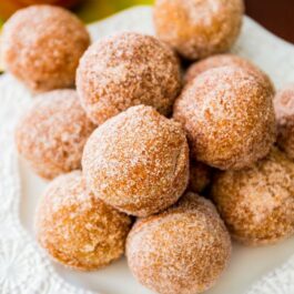apple cider donut holes on a white plate