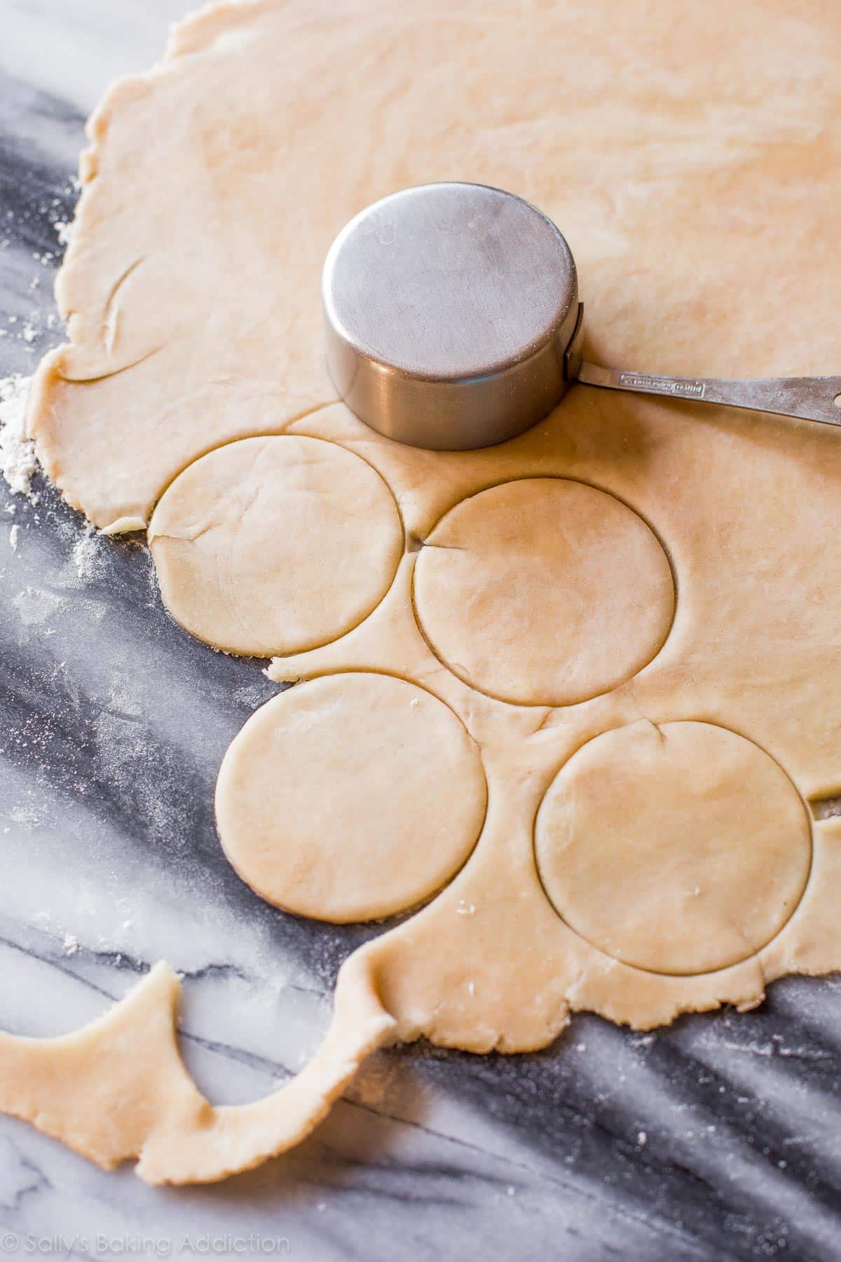 cutting out pie crust circles for pecan pie tarts