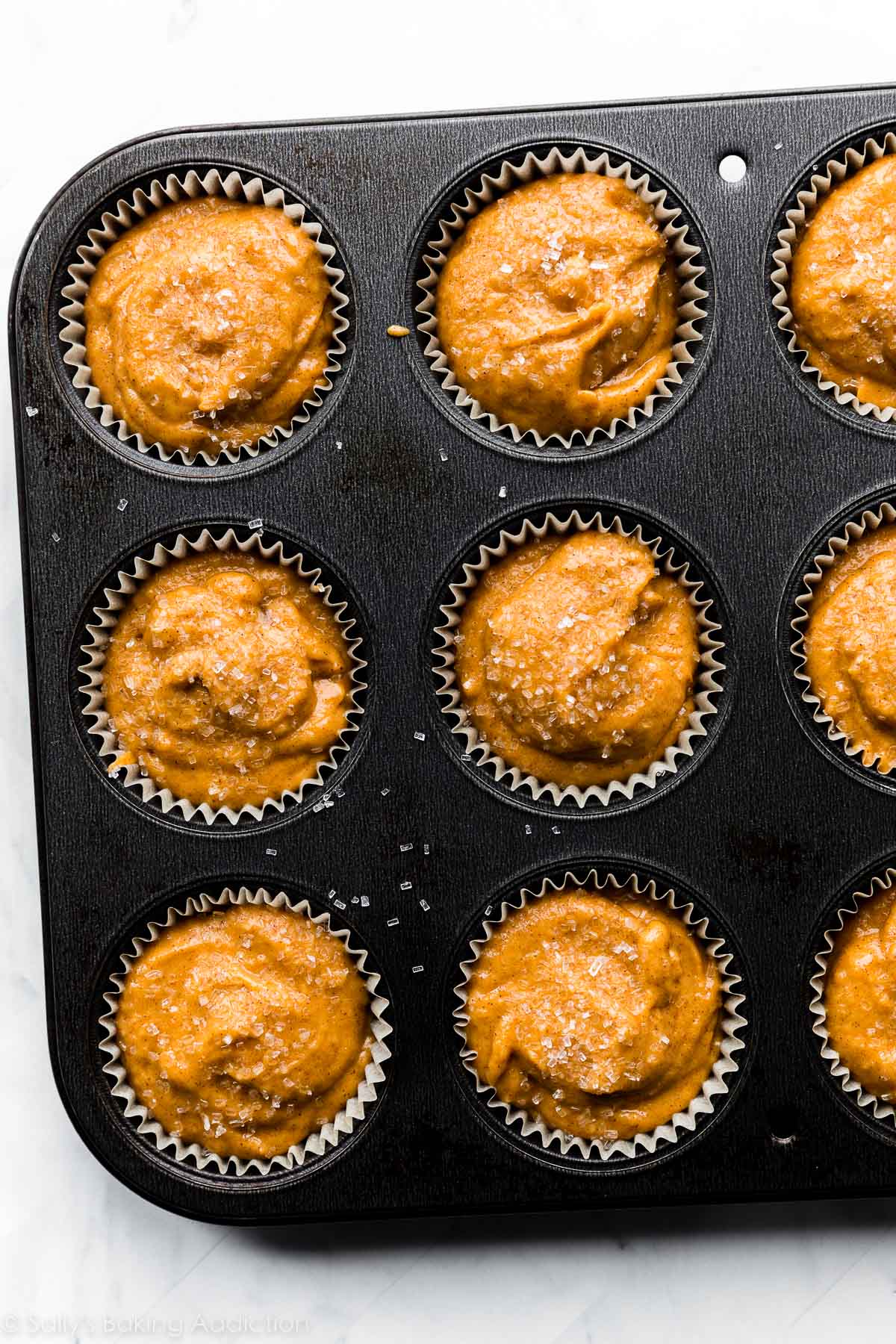 muffins batter in metal muffin pan.