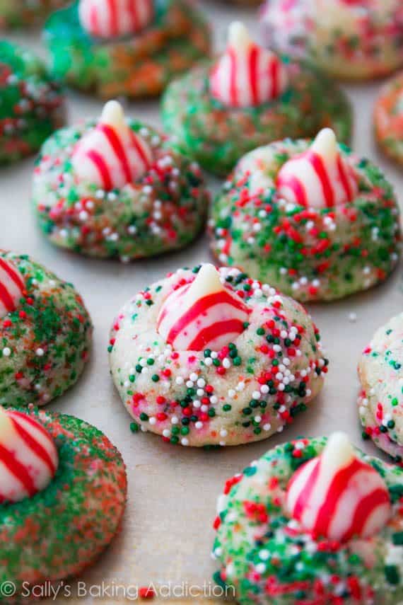 Festive sugar cookies and chocolate cookies stuffed with a Candy Cane Hershey Kiss. Soft, chewy, and easy to make!