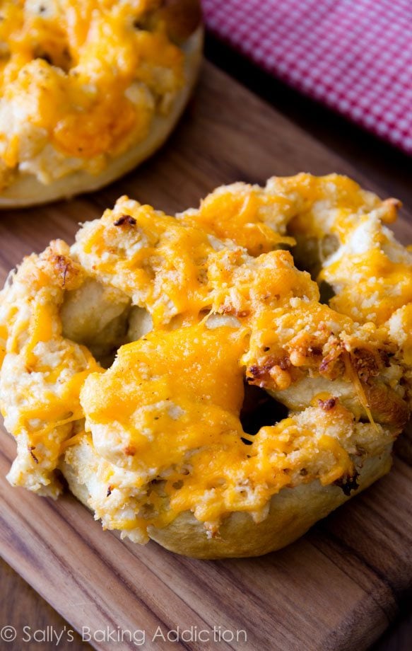 soft pretzels topped with cheesy crab dip on a wood board