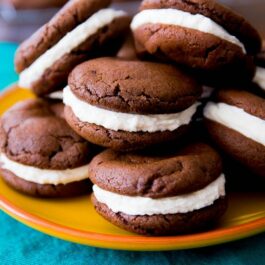 homemade Oreo cookies piled on a yellow plate