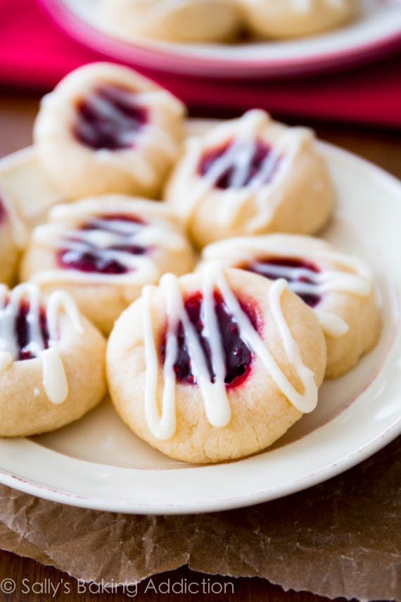 raspberry almond thumbprint cookies on a white plate