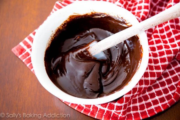 chocolate ganache in a white bowl with a spatula