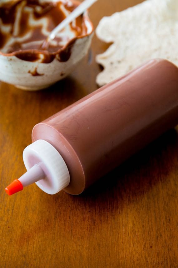 melted chocolate and peanut butter in a plastic squeeze bottle