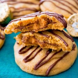 stack of Reese's stuffed peanut butter cookies with one broken in half showing the peanut butter cup inside