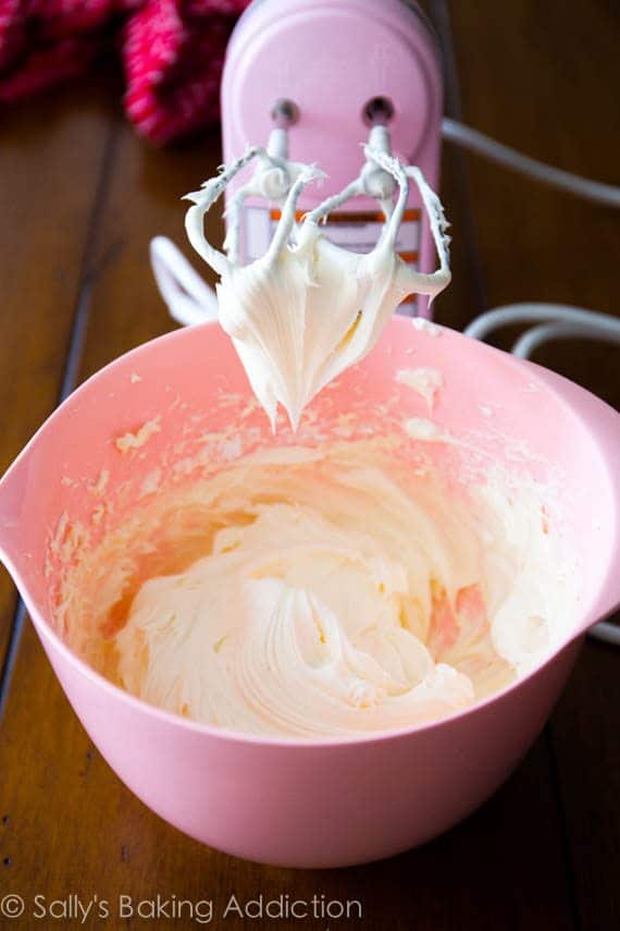 cream cheese frosting in a pink bowl