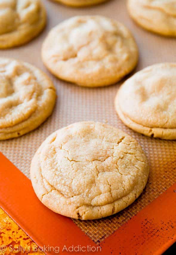 peanut butter cookies stuffed with a Reese's peanut butter cup on a silpat baking mat