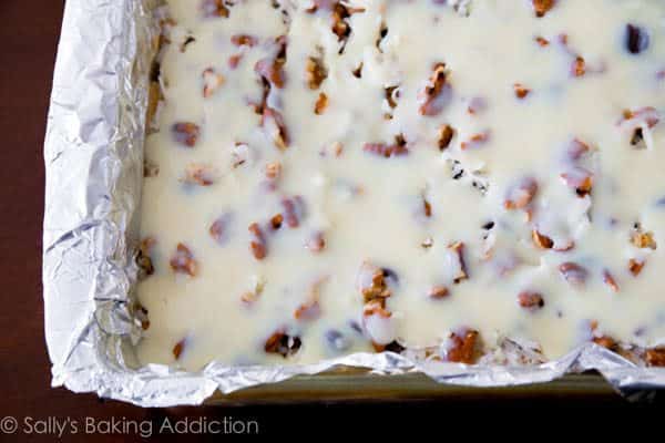 ultimate magic cookie bars in a baking pan lined with foil