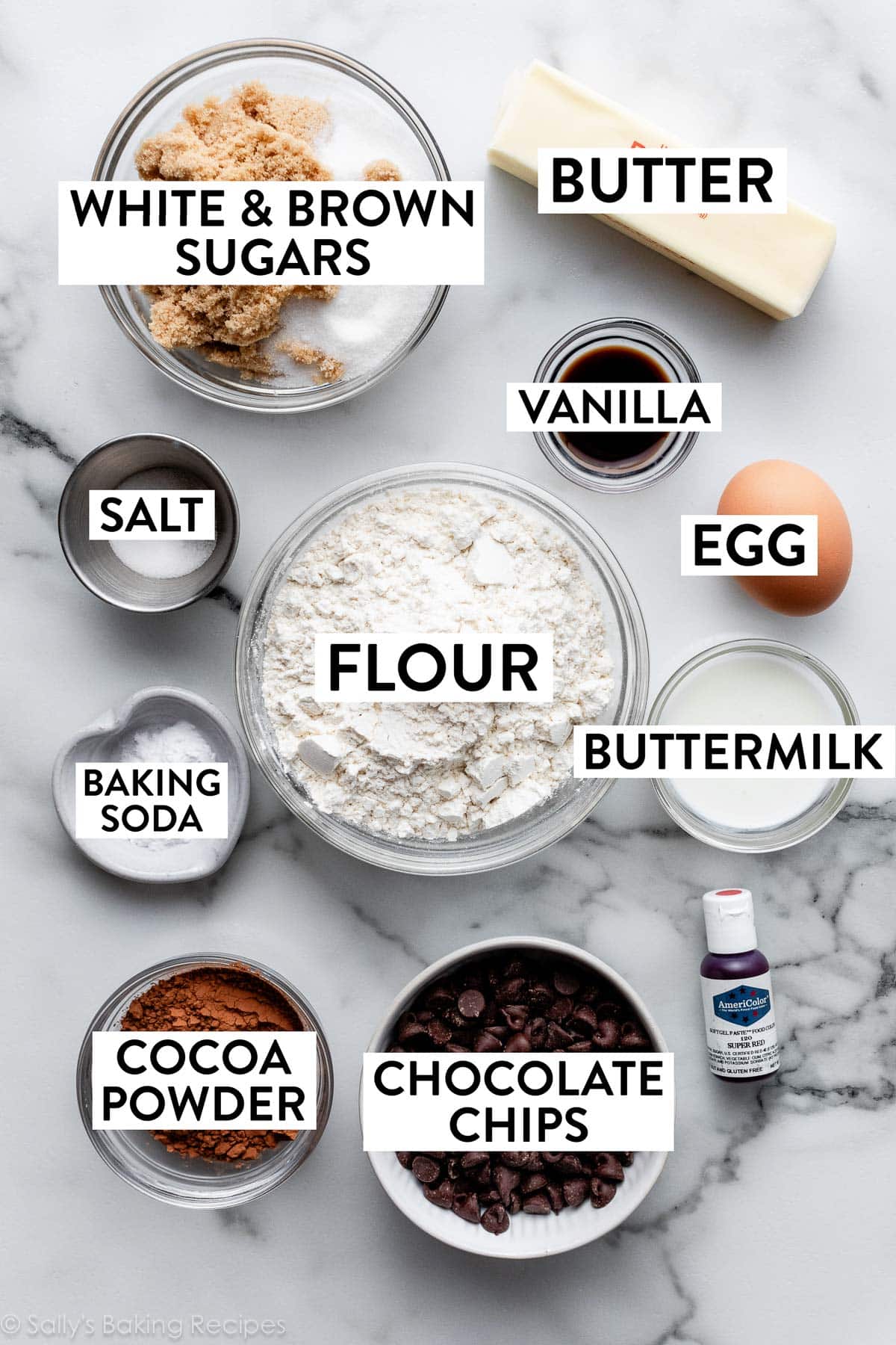 ingredients on counter including cocoa powder, brown and white sugars, butter, vanilla, salt, egg, and buttermilk.