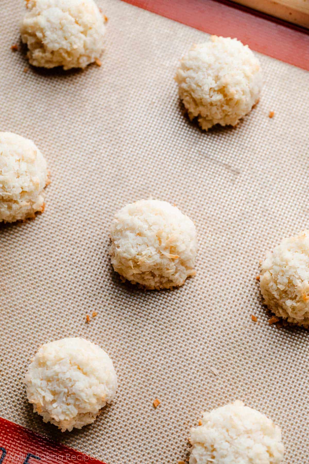 baked coconut macaroons on Silpat-lined baking sheet.