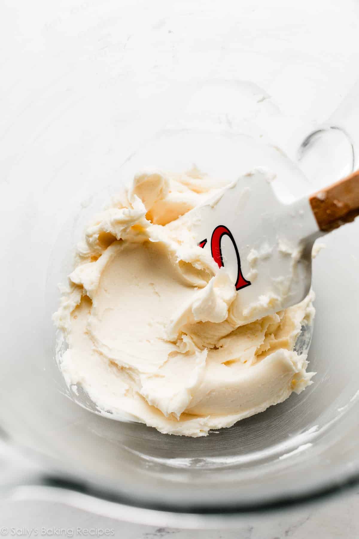 vanilla cream buttercream with spatula in glass bowl.