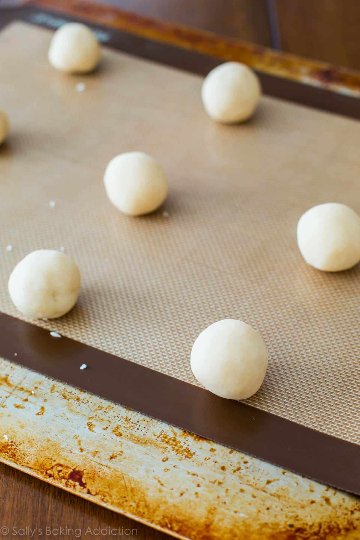 shortbread cookie dough rolled into balls on a baking sheet