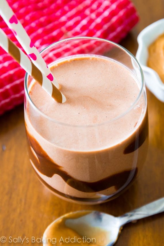 chocolate peanut butter smoothie in a glass with straws