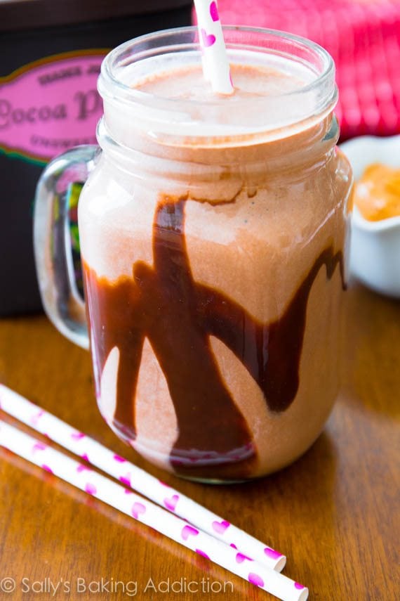 chocolate peanut butter smoothie in a glass mug with a straw