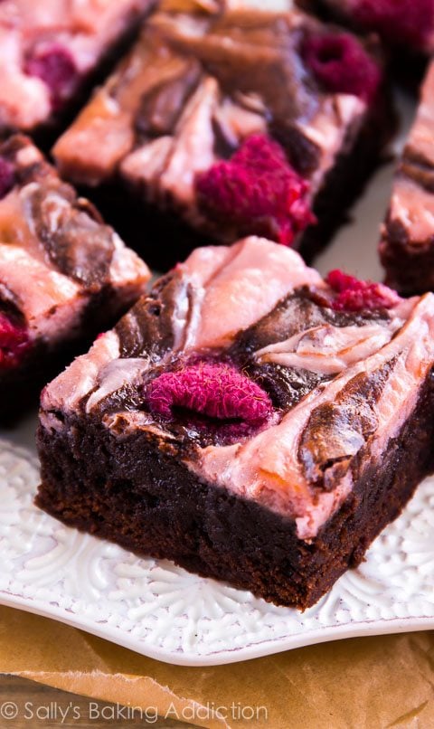 raspberry cheesecake brownies on a white plate