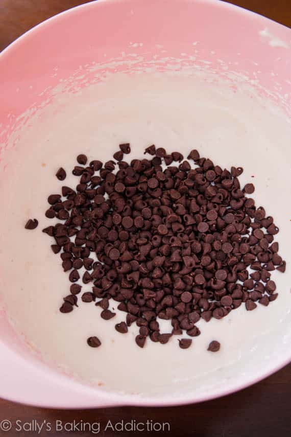 cheesecake batter with chocolate chips on top in a pink bowl