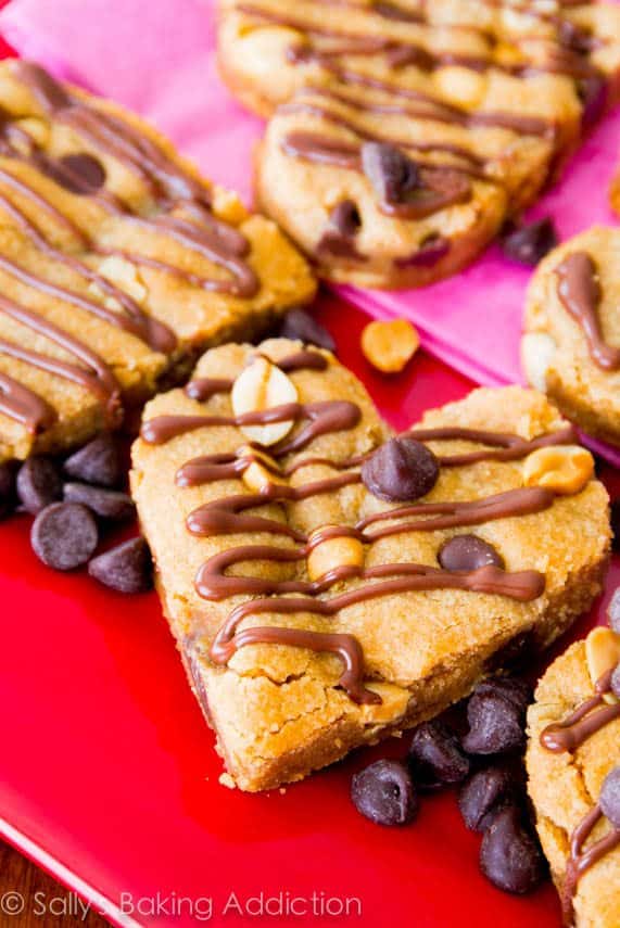 heart shaped whole wheat peanut butter blondies on a red plate
